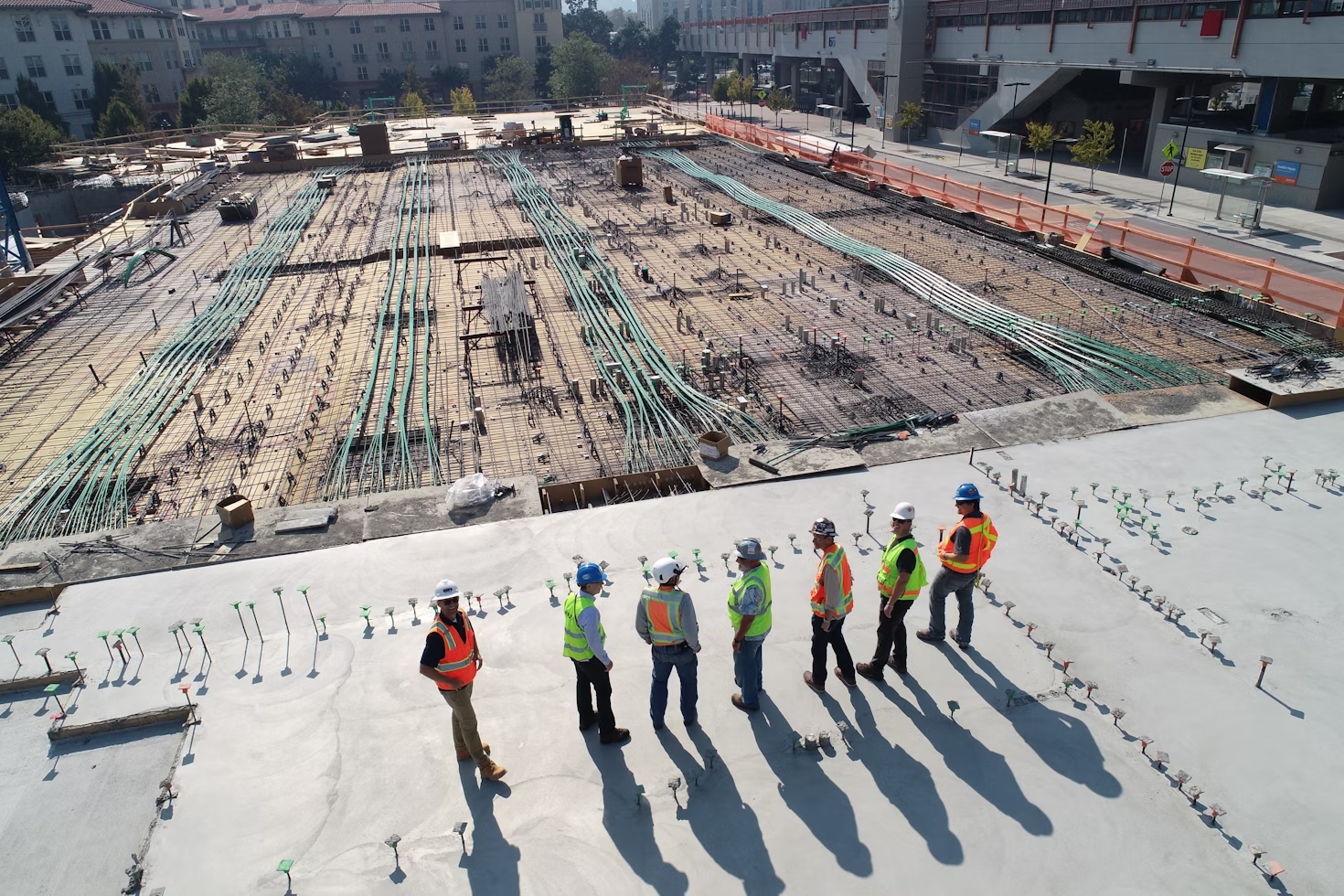 background image; workers on site